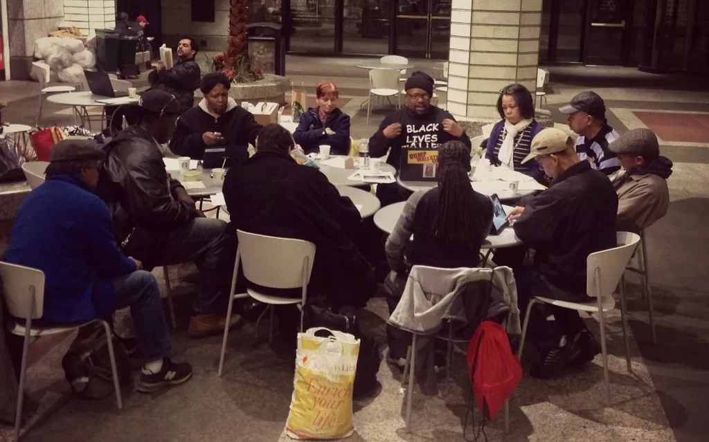 A diverse group of 11 Occu-Evolve organizers gathered at 60 Wall Street Atrium on Friday, April 10, and discussed plans for the upcoming protests. “We have been working with issues dealing with police violence and police brutality,” said Sumumba Sobukwe, 47, leader of Occu-Evolve. “We have members that are part of Stop Mass Incarceration Network that made the call for this citywide, national, international action.” Photo BY Deron Dalton